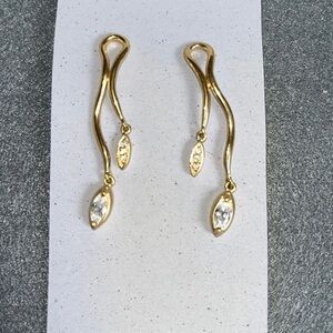 Gold asymmetrical earrings with marquise rhinestones